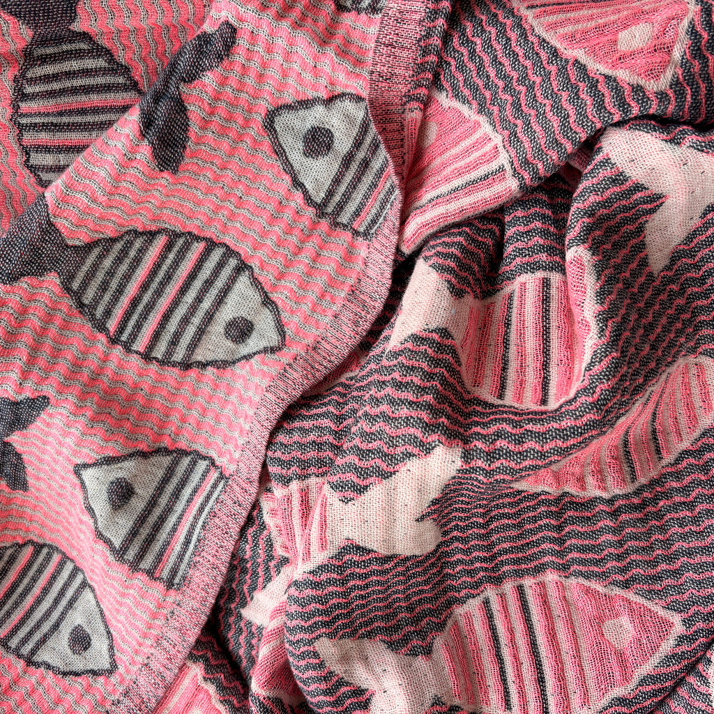 Close-up of pink turkish towel with fish pattern