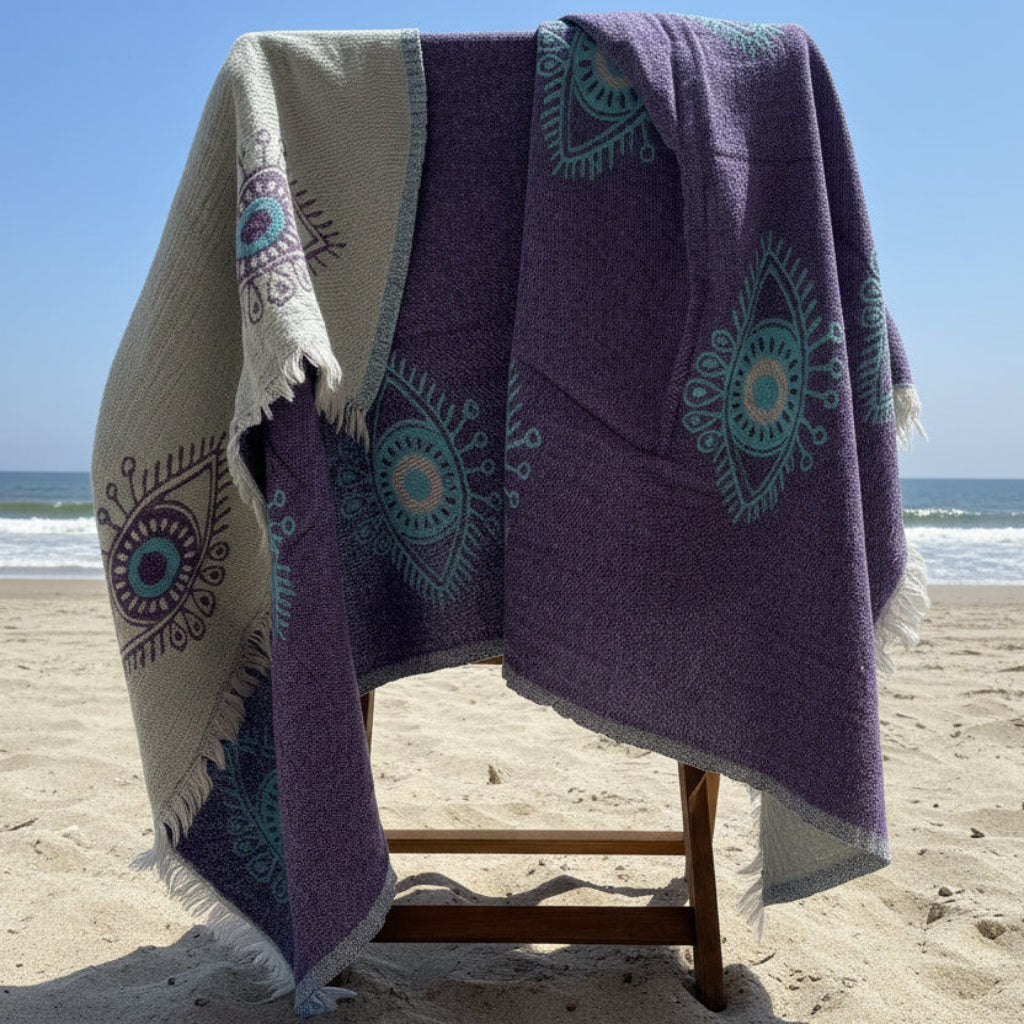 Two towel hanging on a rack against a neutral wall.