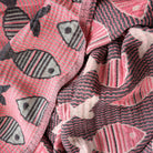Close-up of pink turkish towel with fish pattern