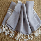 Hand-loomed light grey Turkish towel with traditional fringe